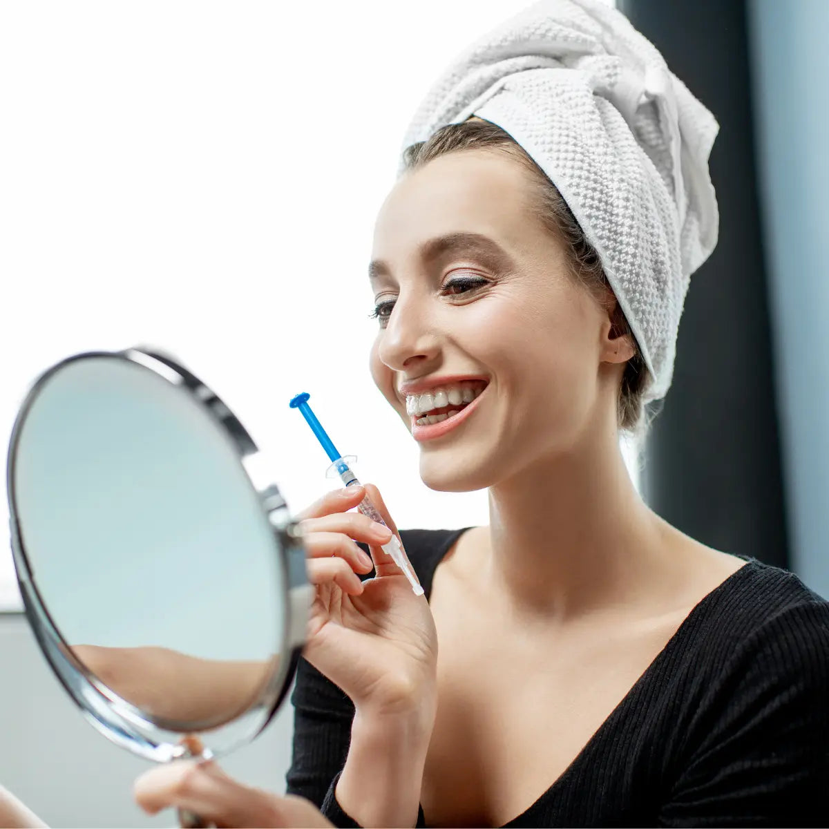 The lady who smiles into the mirror and holds the teeth whitening gel